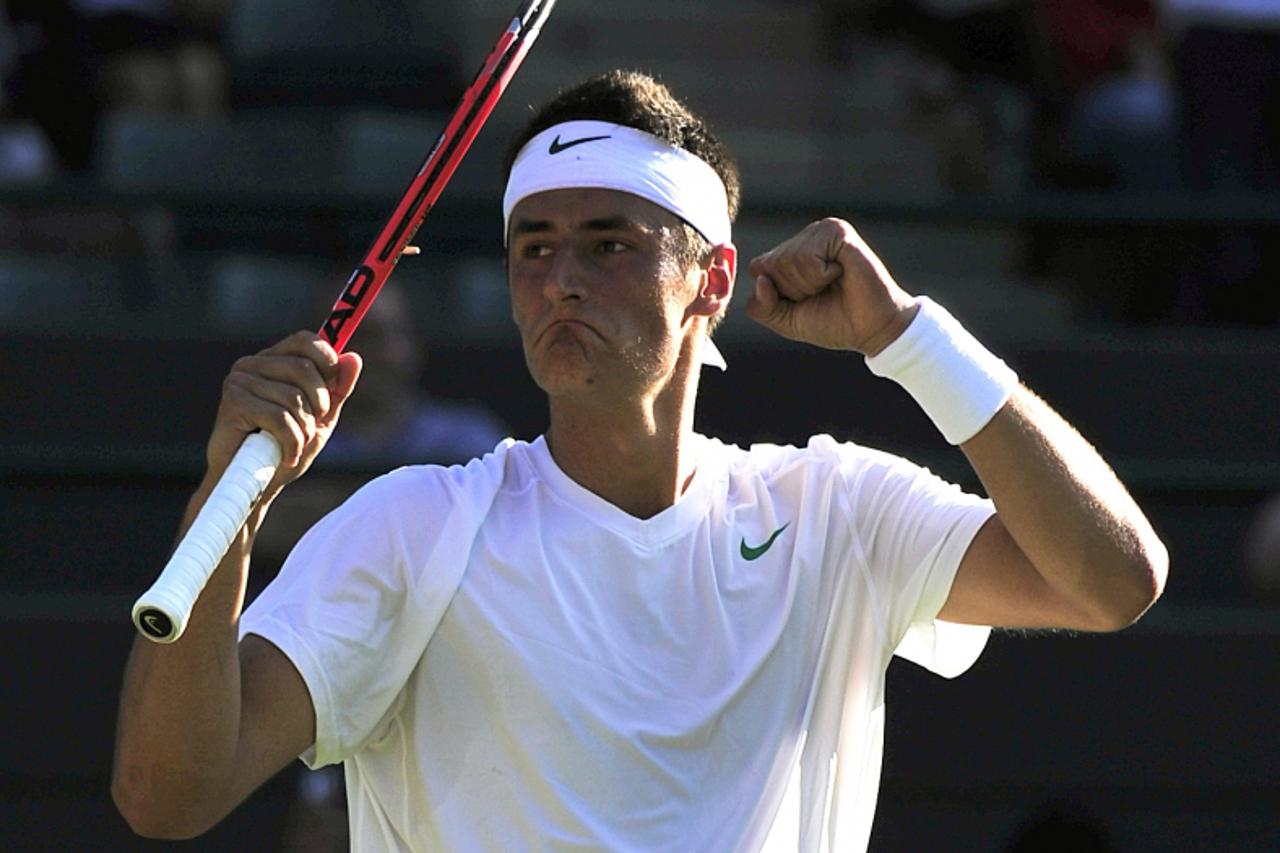 'Australian player Bernard Tomic reacts after beating Swedish player Robin Soderling during the men\'s single at the Wimbledon Tennis Championships at the All England Tennis Club, in southwest London 