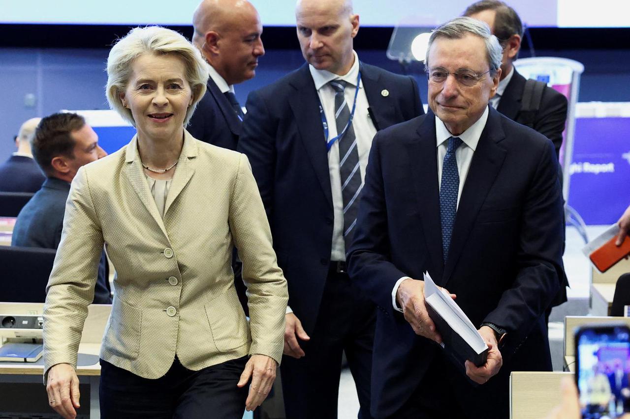 European Commission President Ursula von der Leyen walks with Former European Central Bank (ECB) chief Mario Draghi, on the day of their keynote address, in Brussels