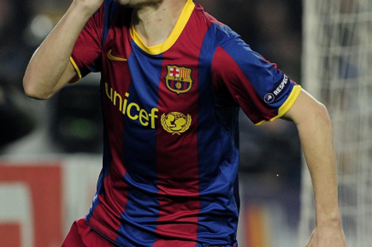 'Barcelona\'s midfielder Andres Iniesta celebrates after scoring during the Champions League quarter-final first leg football match Barcelona against Shakhtar Donetsk at the Camp Nou stadium in Barcel