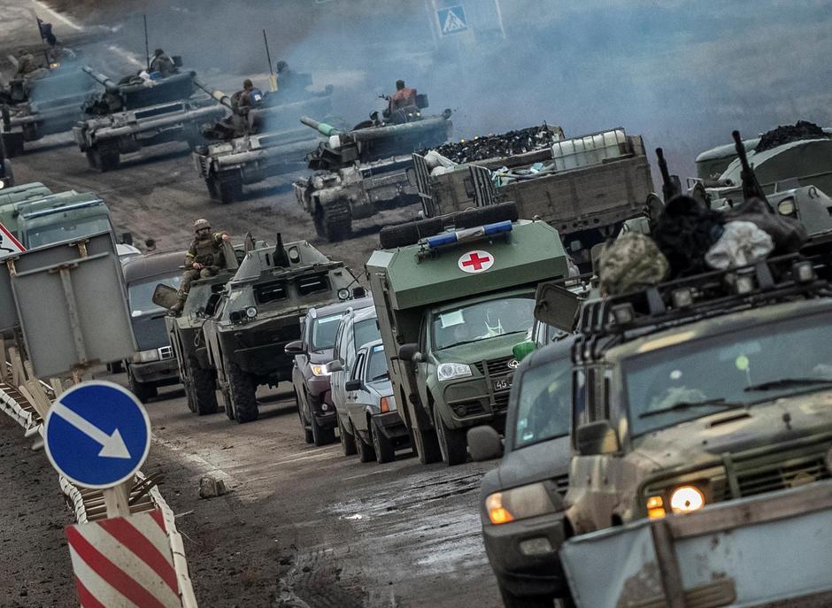 Ukrainian tanks and military vehicles are seen at a road in Kherson region