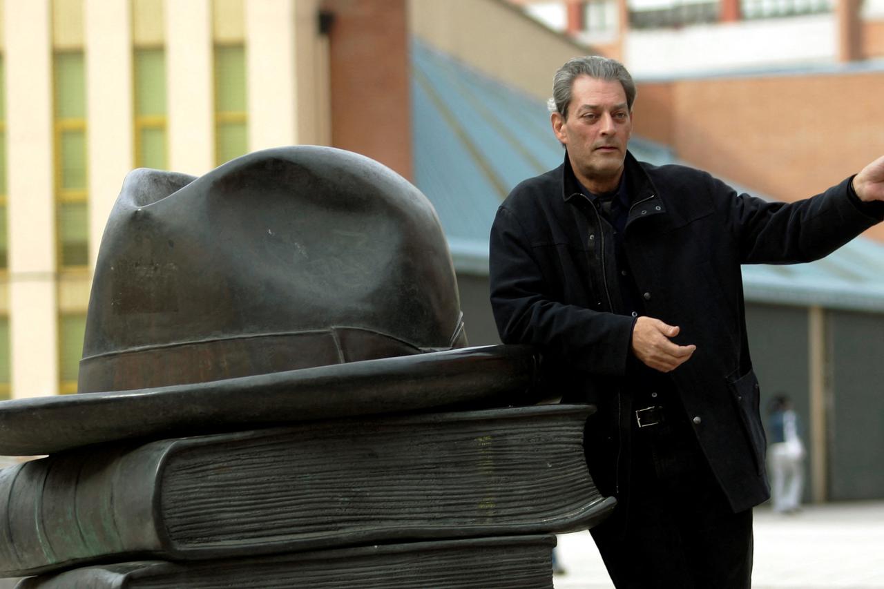 FILE PHOTO: US writer Auster poses before conference on literature at Campus del Milán library in Oviedo