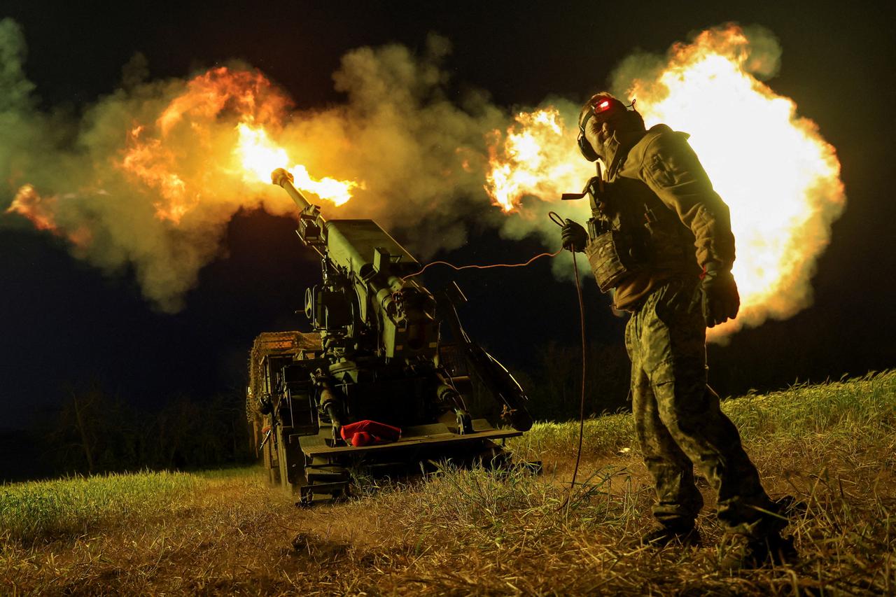 Ukrainian servicemen fire a self-propelled howitzer toward Russian positions on a frontline in Donetsk region