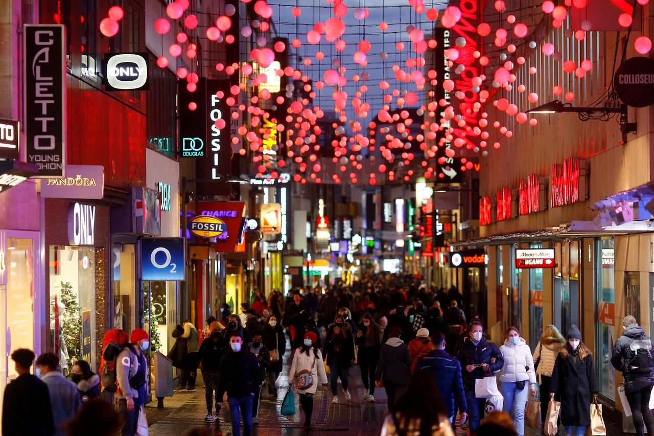 FILE PHOTO: Shoppers walk down the main shopping street Hohe Strasse in Cologne