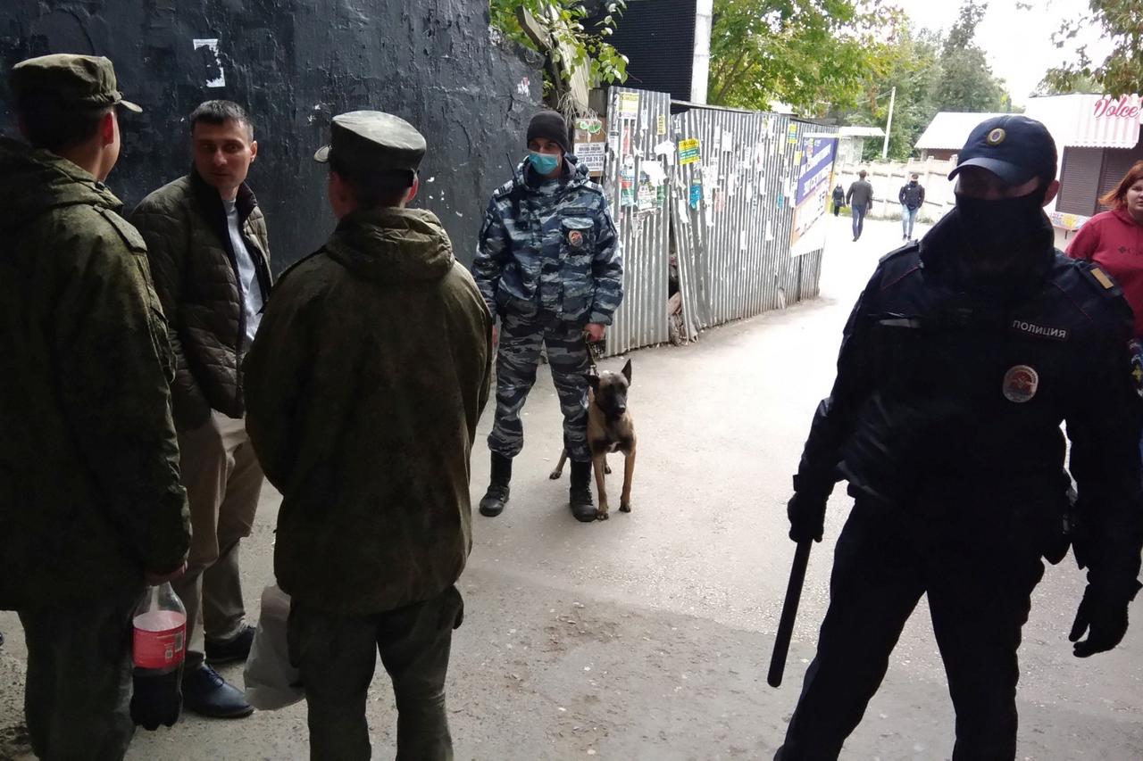 Law enforcement officers are seen near the scene of a shooting at university in Perm