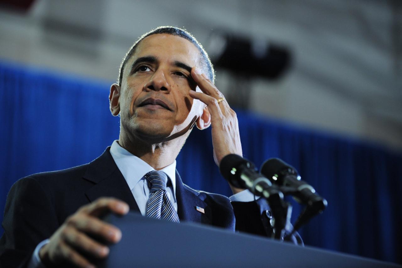 'US President Barack Obama wipes his brow as he speaks on the economy and an extension of the payroll tax cut at Osawatomie High School December 6, 2011 in Osawatomie, Kansas. AFP PHOTO/Mandel NGAN'