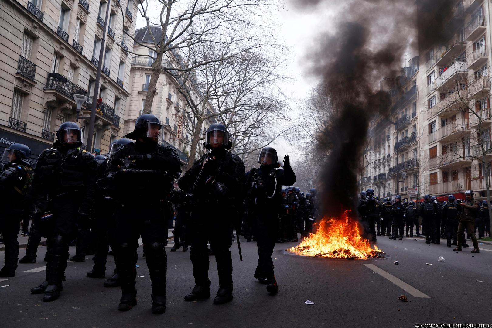 French gendarmes and riot police stand in position near a fire during clashes at a demonstration as part of the tenth day of nationwide strikes and protests against French government's pension reform, in Paris, France, March 28, 2023. REUTERS/Gonzalo Fuentes Photo: GONZALO FUENTES/REUTERS