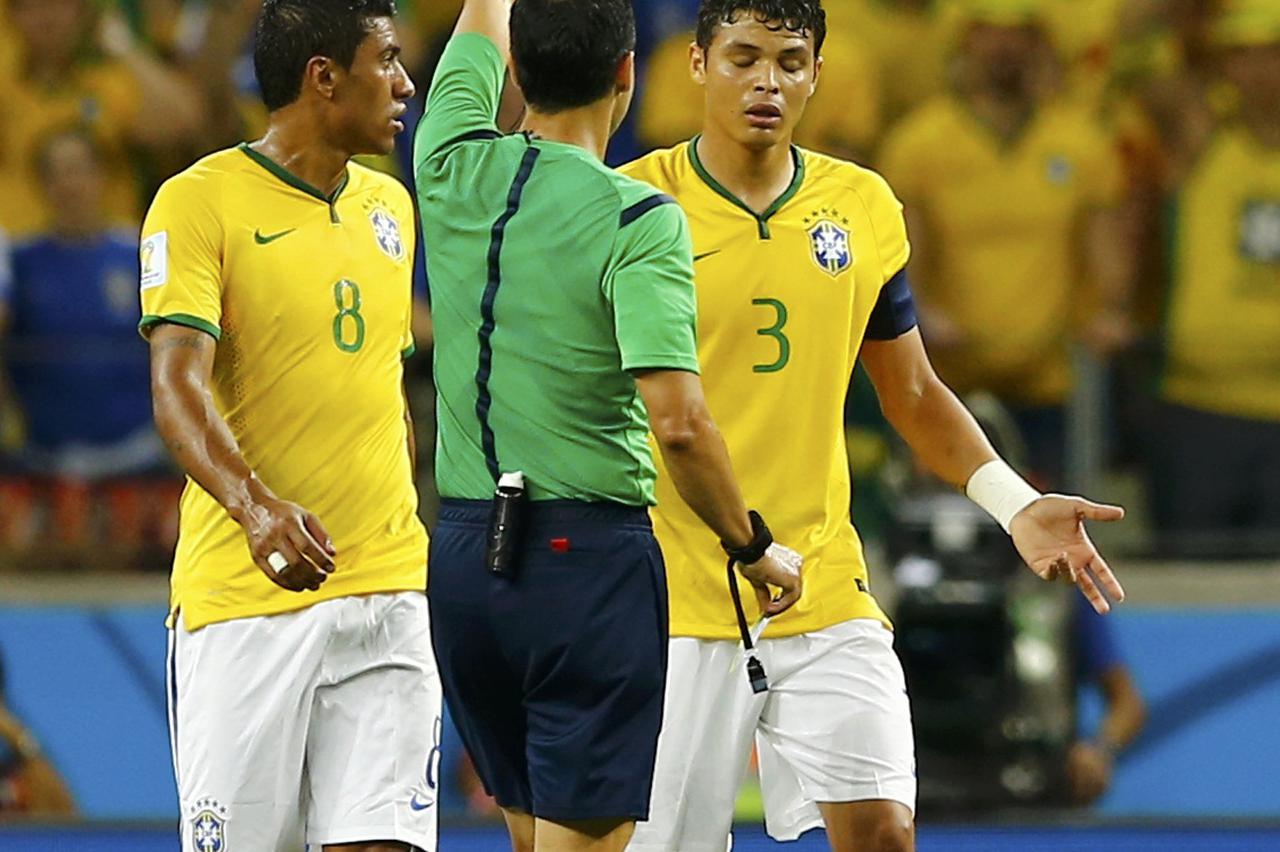 Referee Carlos Velasco Carballo of Spain shows Brazil's Thiago Silva the yellow card during the 2014 World Cup quarter-finals between Brazil and Colombia at the Castelao arena in Fortaleza July 4, 2014. REUTERS/Marcelo Del Pozo (BRAZIL  - Tags: TPX IMAGES