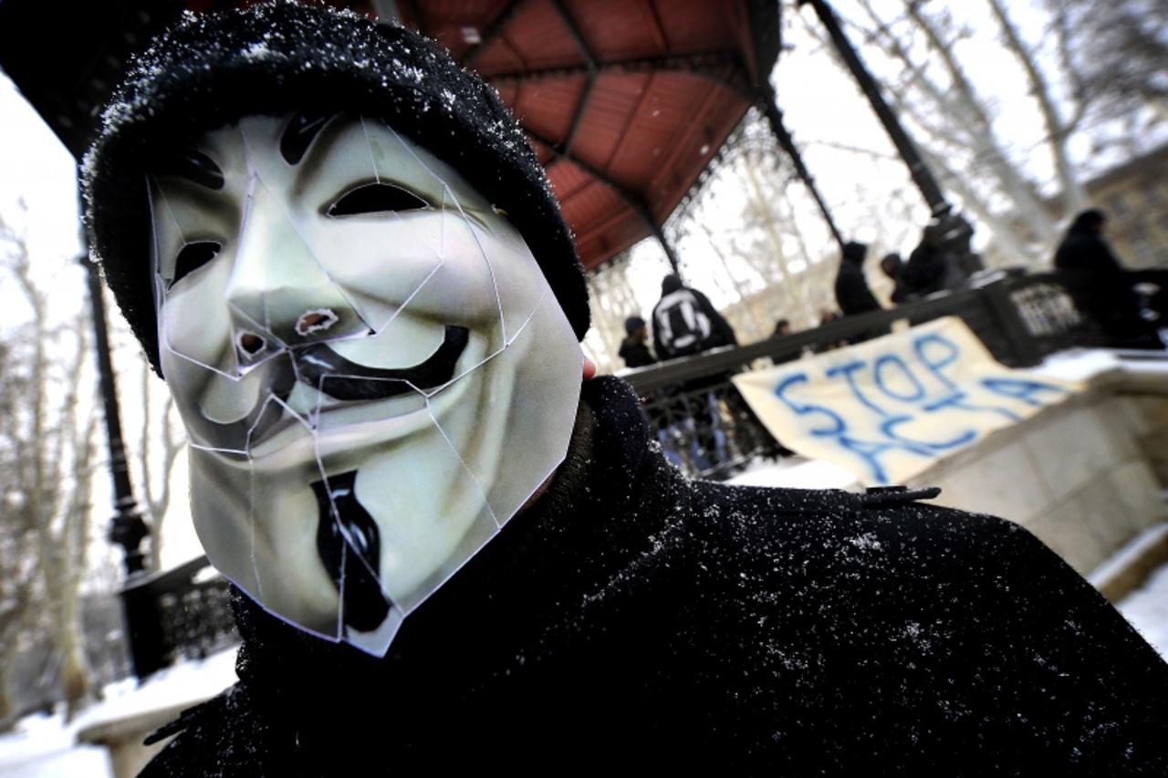 'A protester wearing an Anonymous Guy Fawkes mask takes part in a demonstration against controversial Anti-Counterfeiting Trade Agreement (ACTA) as part of an international day of action against the i