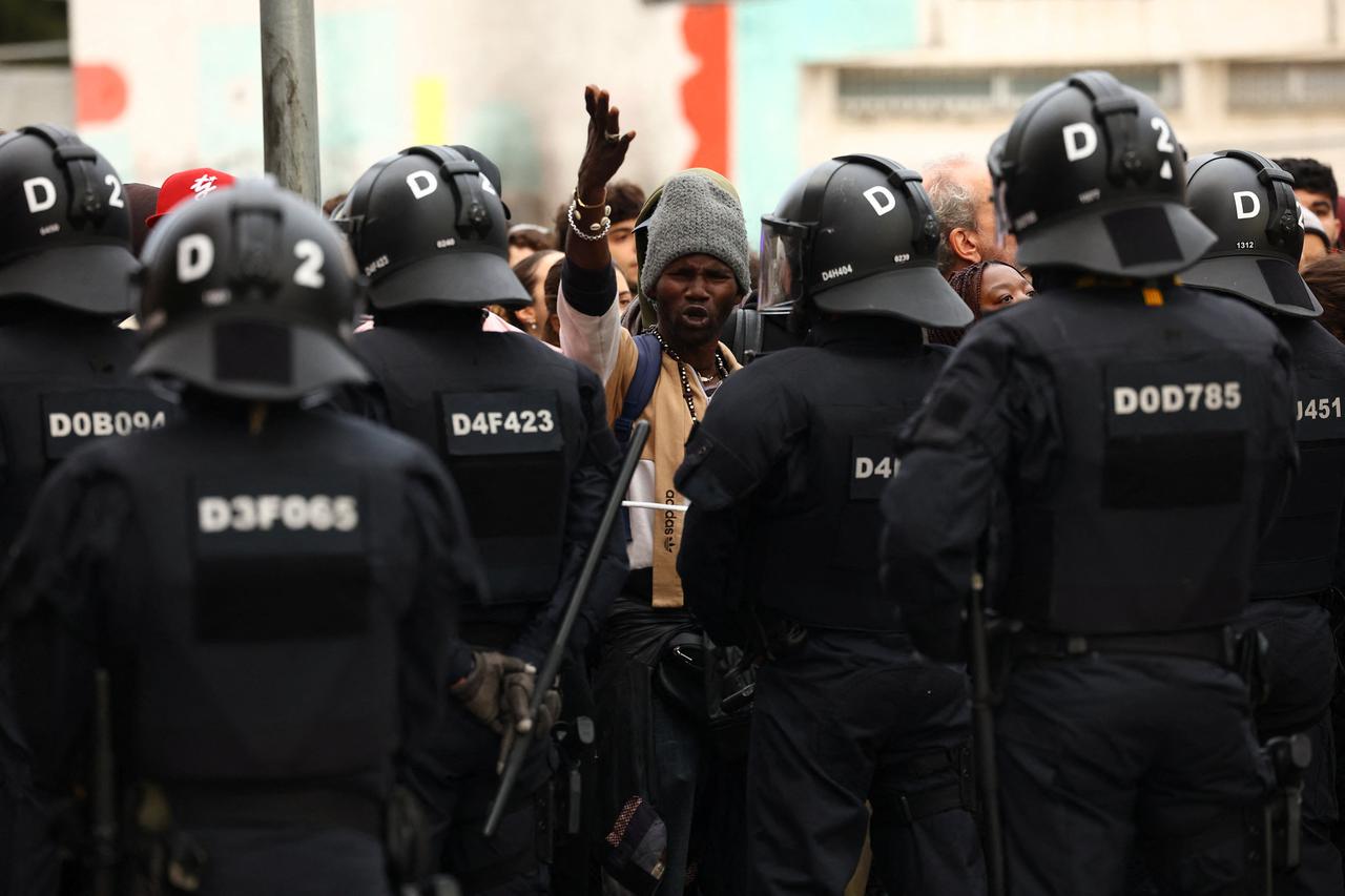 Police officers evict migrants from a former school in Badalona