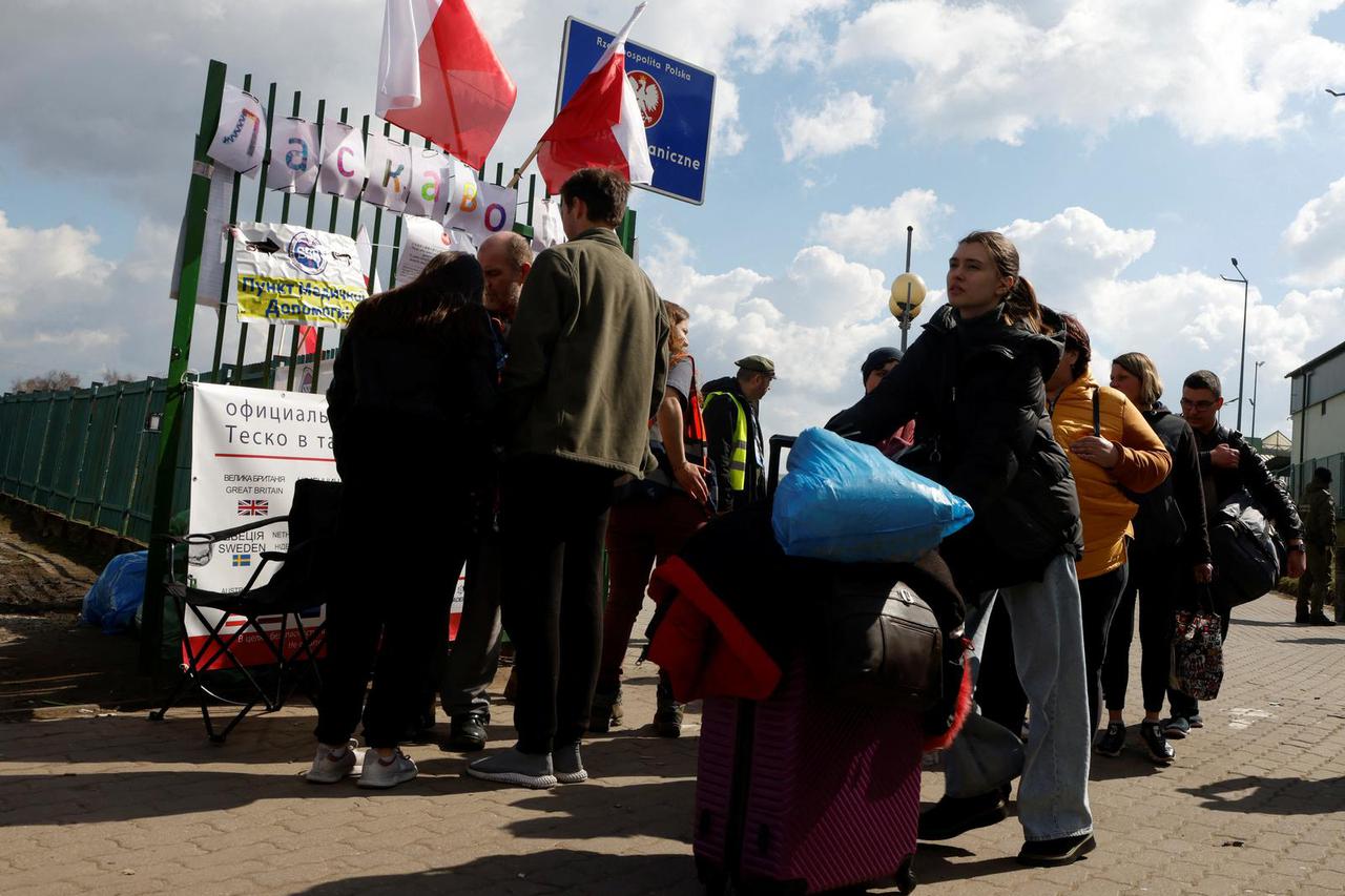 People fleeing from Russia's invasion of Ukraine cross the border in Medyka
