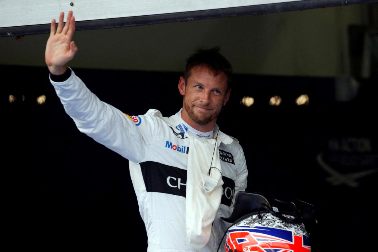 FILE PHOTO: McLaren's Jenson Button of Britain waves after a qualifying session at the Formula One Malaysia Grand Prix in Sepang, Malaysia