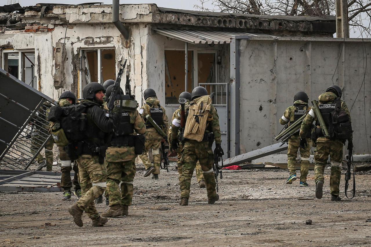 Service members from Chechen Republic walk during fighting in Ukraine-Russia conflict in the city of Mariupol