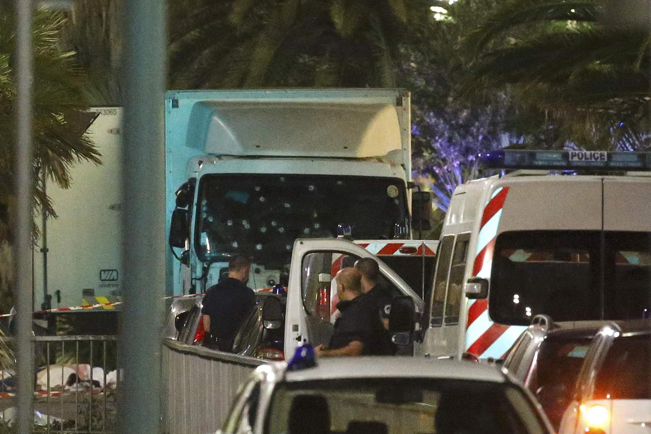 French police forces and forensic officers stand next to a truck July 15, 2016 that ran into a crowd celebrating the Bastille Day national holiday on the Promenade des Anglais killing at least 60 people in Nice, France, July 14.   REUTERS/Eric Gaillard