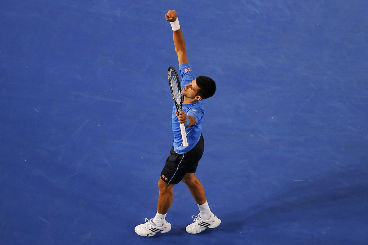 Novak Djokovic of Serbia celebrates after defeating Stan Wawrinka of Switzerland in their men's singles semi-final match at the Australian Open 2015 tennis tournament in Melbourne January 30, 2015.     REUTERS/Carlos Barria (AUSTRALIA  - Tags: SPORT TENNI