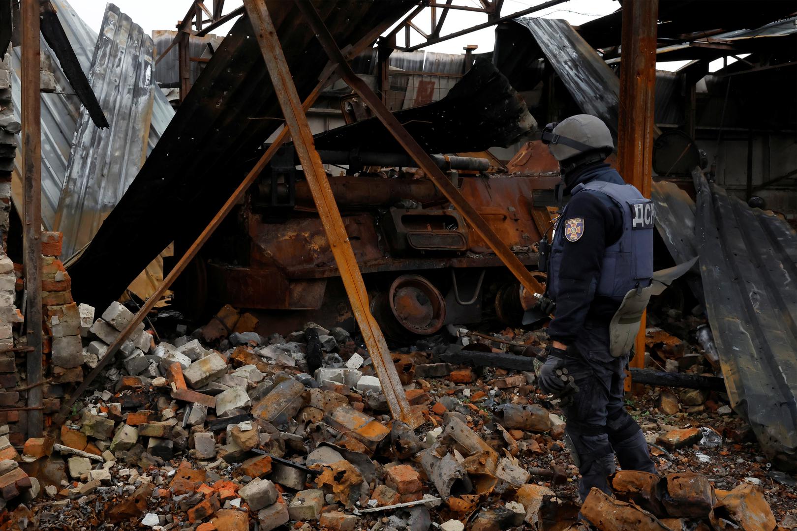 Firefighter Alexander from the de-mining squad of the Ukrainian emergency services enters a burned out tank to search, as they clear an area from shells and other explosive devices, as Russia's invasion of Ukraine continues, close to the Russian border in Kazacha Lopan, Ukraine, October 25, 2022. REUTERS/Clodagh Kilcoyne Photo: Clodagh Kilcoyne/REUTERS