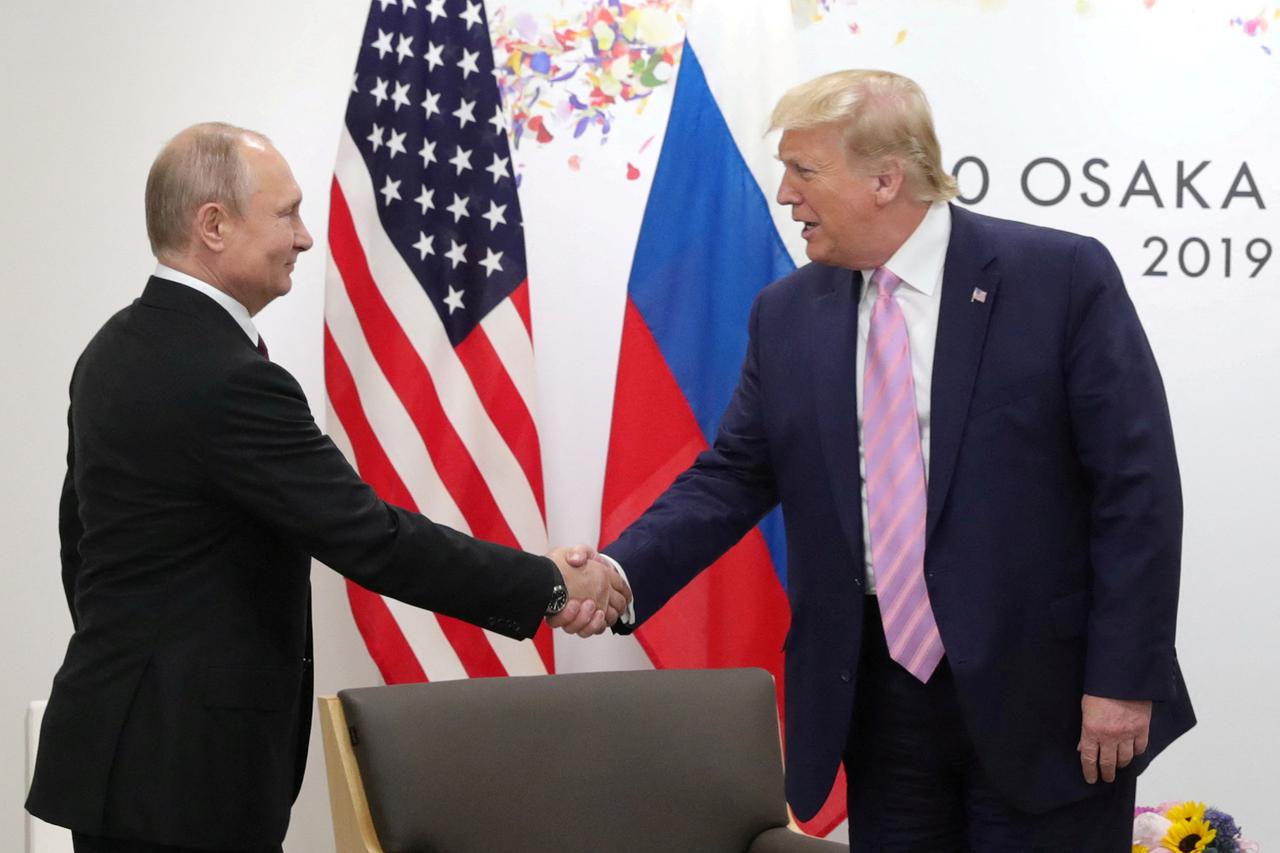 FILE PHOTO: Russia's President Vladimir Putin and U.S. President Donald Trump attend a meeting on the sidelines of the G20 summit in Osaka