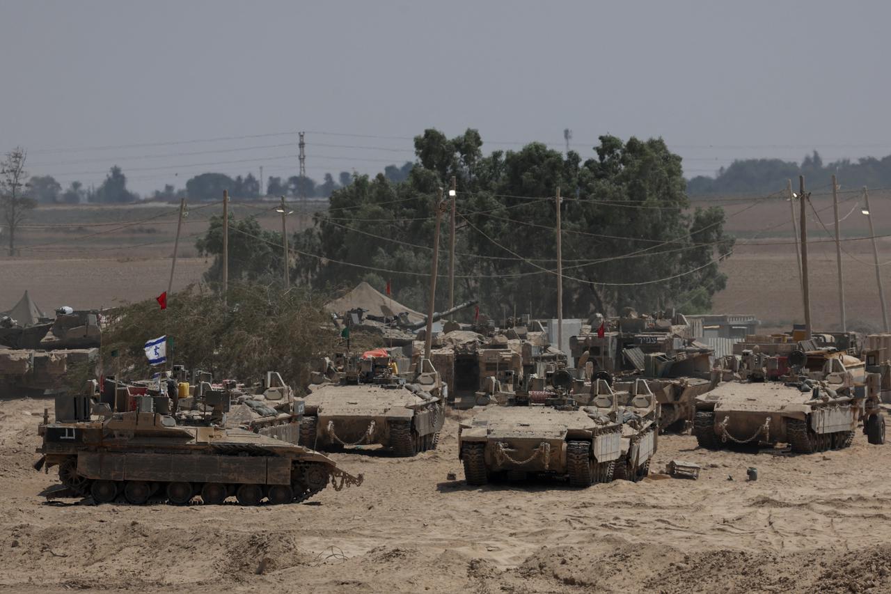 Israeli military vehicles stand near the Israel-Gaza border, in Israel