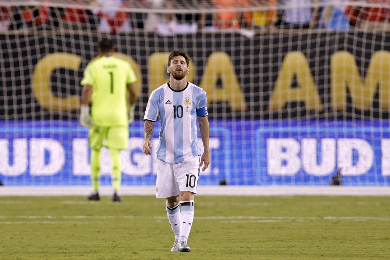 Jun 26, 2016; East Rutherford, NJ, USA; Argentina midfielder Lionel Messi (10) reacts after missing a shot during the shoot out round against Chile in the championship match of the 2016 Copa America Centenario soccer tournament at MetLife Stadium. Chile w