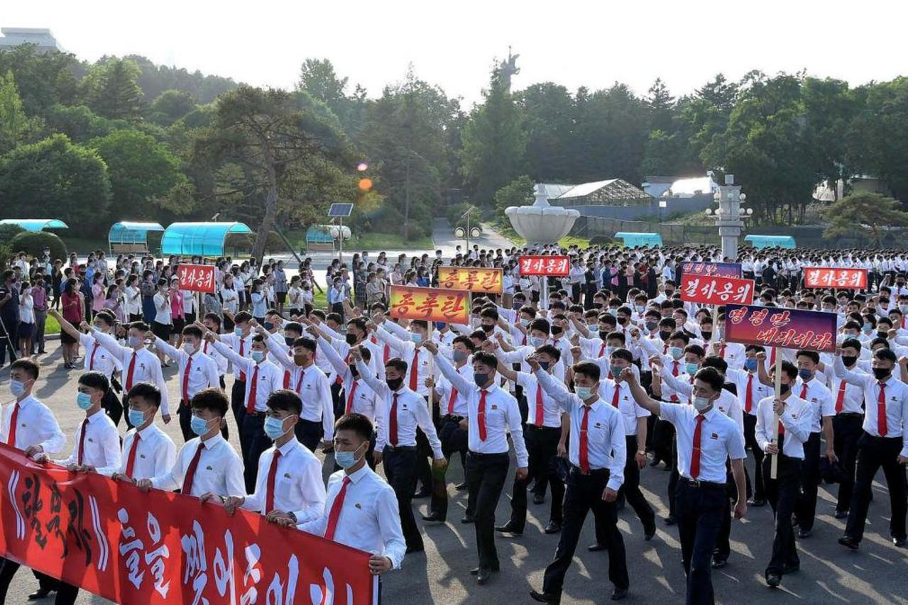 Youths and students wearing protective face masks participate in a demonstration against South Korea and North Korean defectors, in North Korea