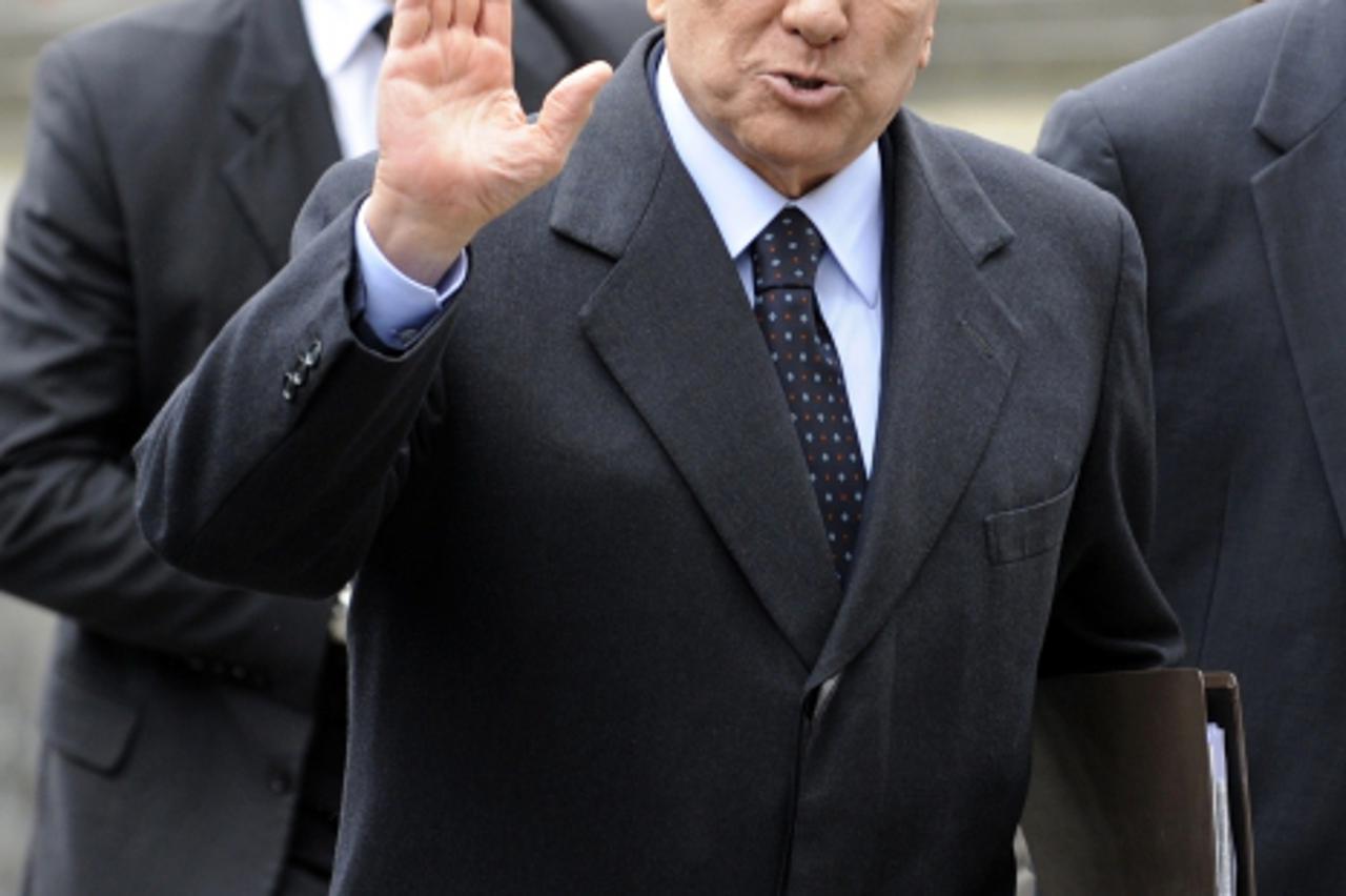 'Italy\'s former Prime Minister Silvio Berlusconi waves as he arrives for the European People\'s Party (EPP) meeting held ahead of a European Union summit on March 1, 2012 in Brussels. European Union 