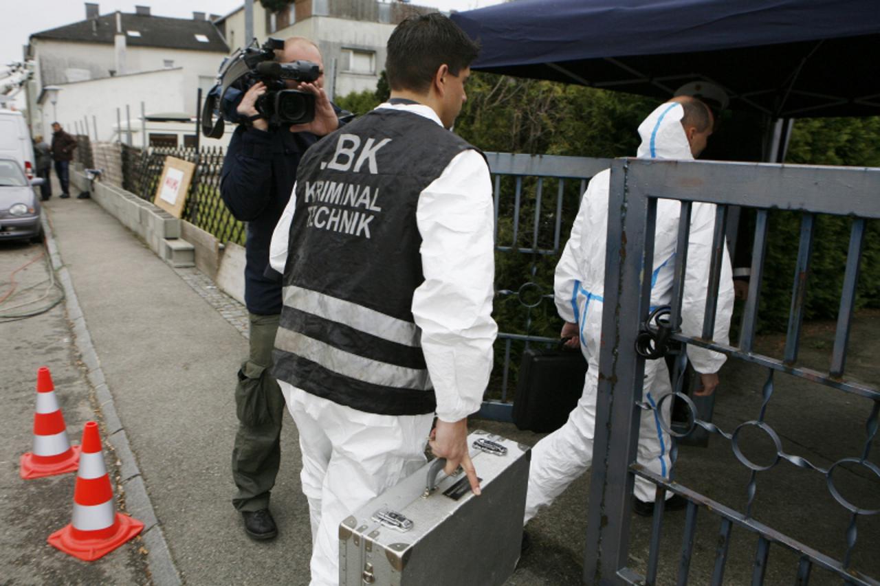 'CSI Police officers enter the back entrance of the house of Austrian Josef Fritzl in Amstetten on May 5, 2008.  Josef Fritzl, 73, who was arrested on April 26, 2008, waits for his trial in the prison