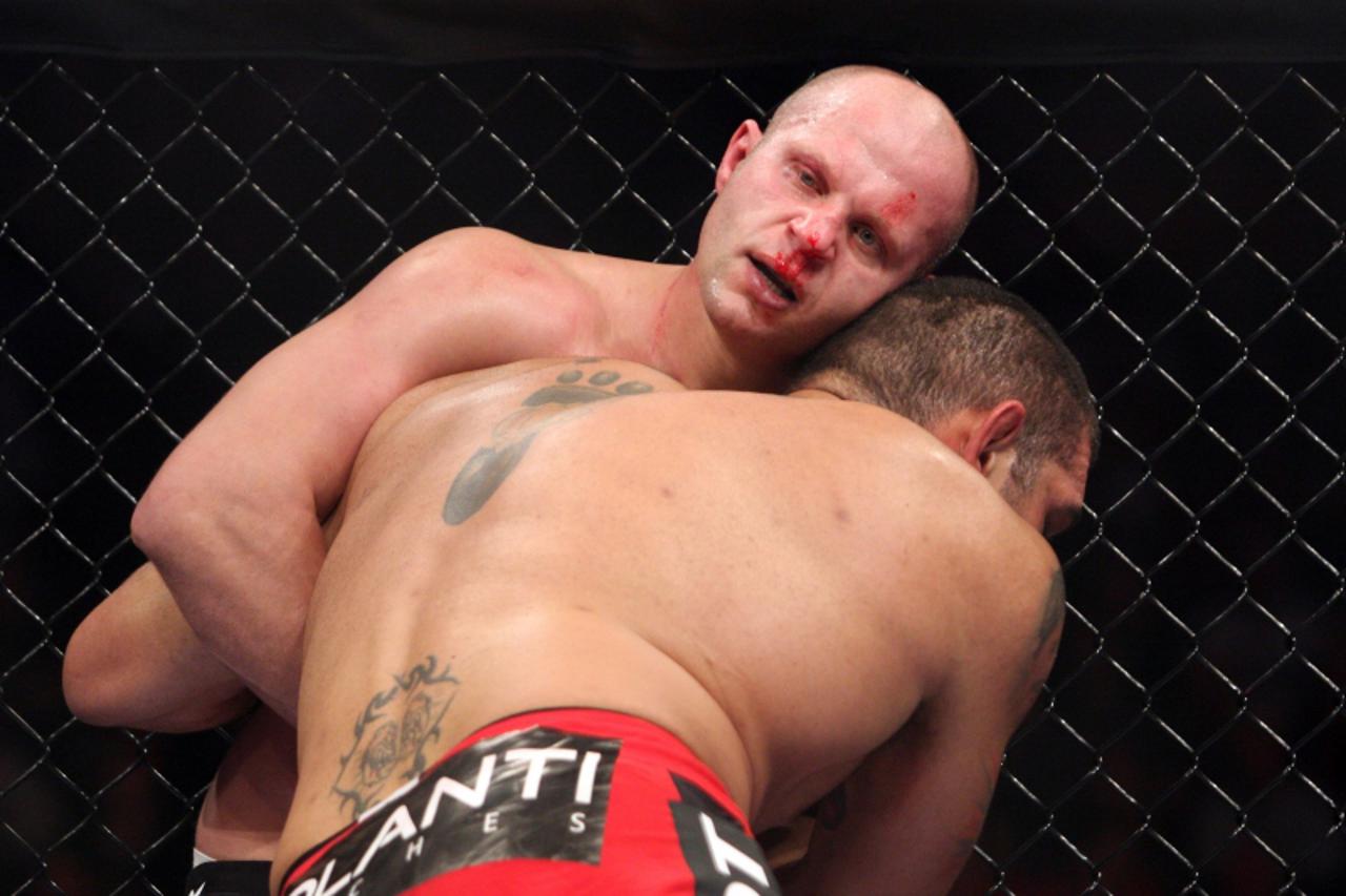 'Fedor Emelianenko, of Russia, is pushed against the cage by Antonio Silva, of Brazil, during a UFC Heavyweight Grand Prix fight on Saturday, Feb. 12, 2011 at the Izod Center in East Rutherford, N.J. 
