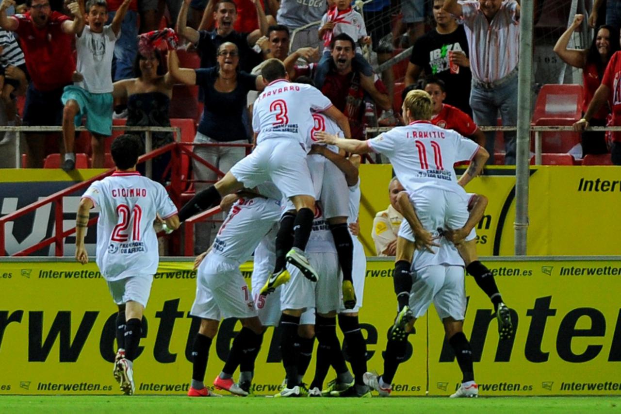 'Sevilla FC's players celebrate after scoring during the Spanish league football match between Sevilla FC and Real Madrid on September 15, 2012 at the Ramon Sanchez Pizjuan stadium in Sevilla. AFP PH