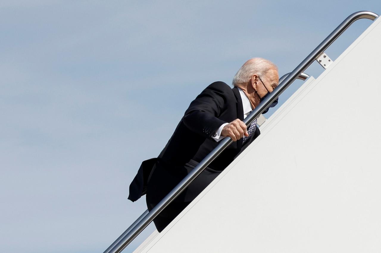 U.S. President Joe Biden stumbles on steps departs on travel to Atlanta, Georgia at Joint Base Andrews in Maryland