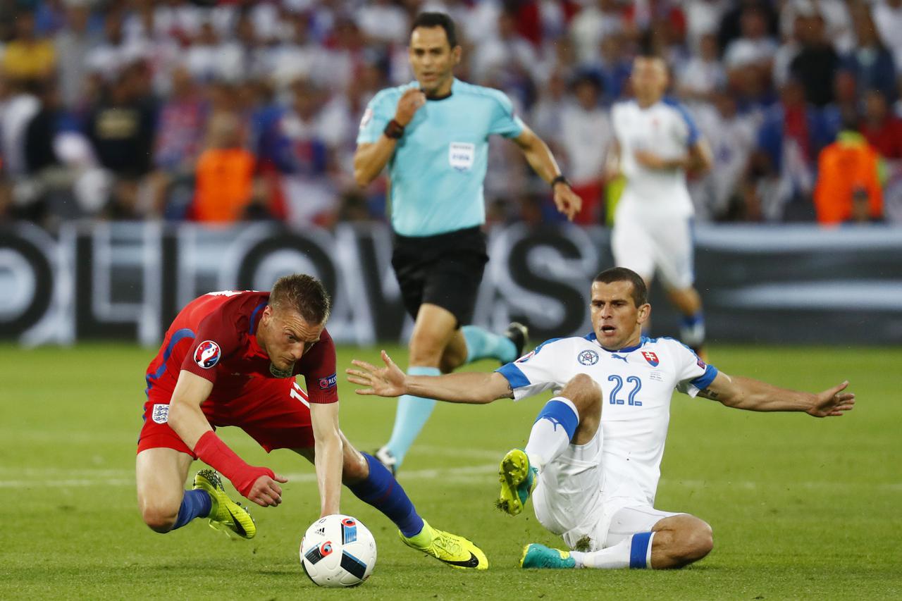Football Soccer - Slovakia v England - EURO 2016 - Group B - Stade Geoffroy-Guichard, Saint-Étienne, France - 20/6/16 Slovakia's Viktor Pecovsky fouls England's Jamie Vardy and is later shown a yellow card by referee Carlos Velasco Carballo REUTERS/Kai Pf
