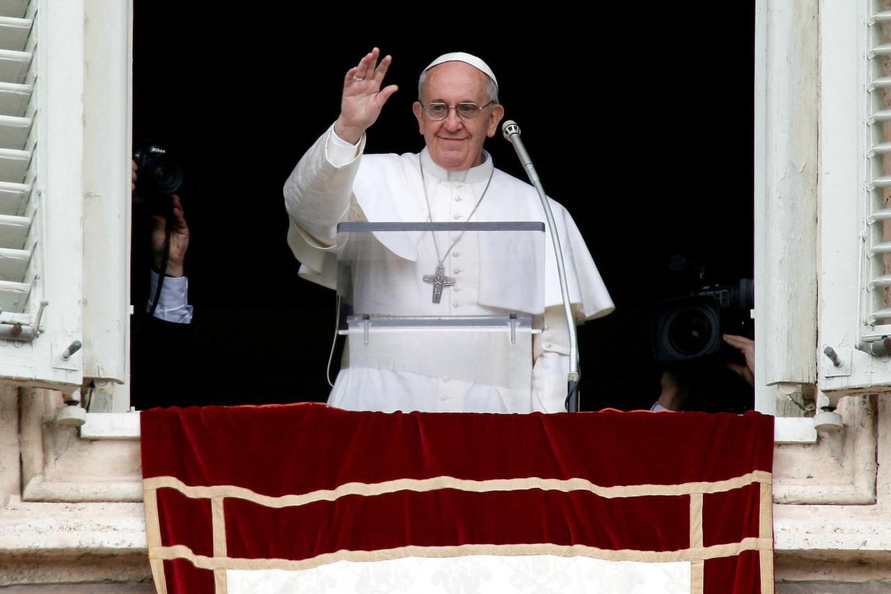 FILE PHOTO: Newly elected Pope Francis appears at the window of his future private apartment to bless faithful during Angelus prayer at Vatican