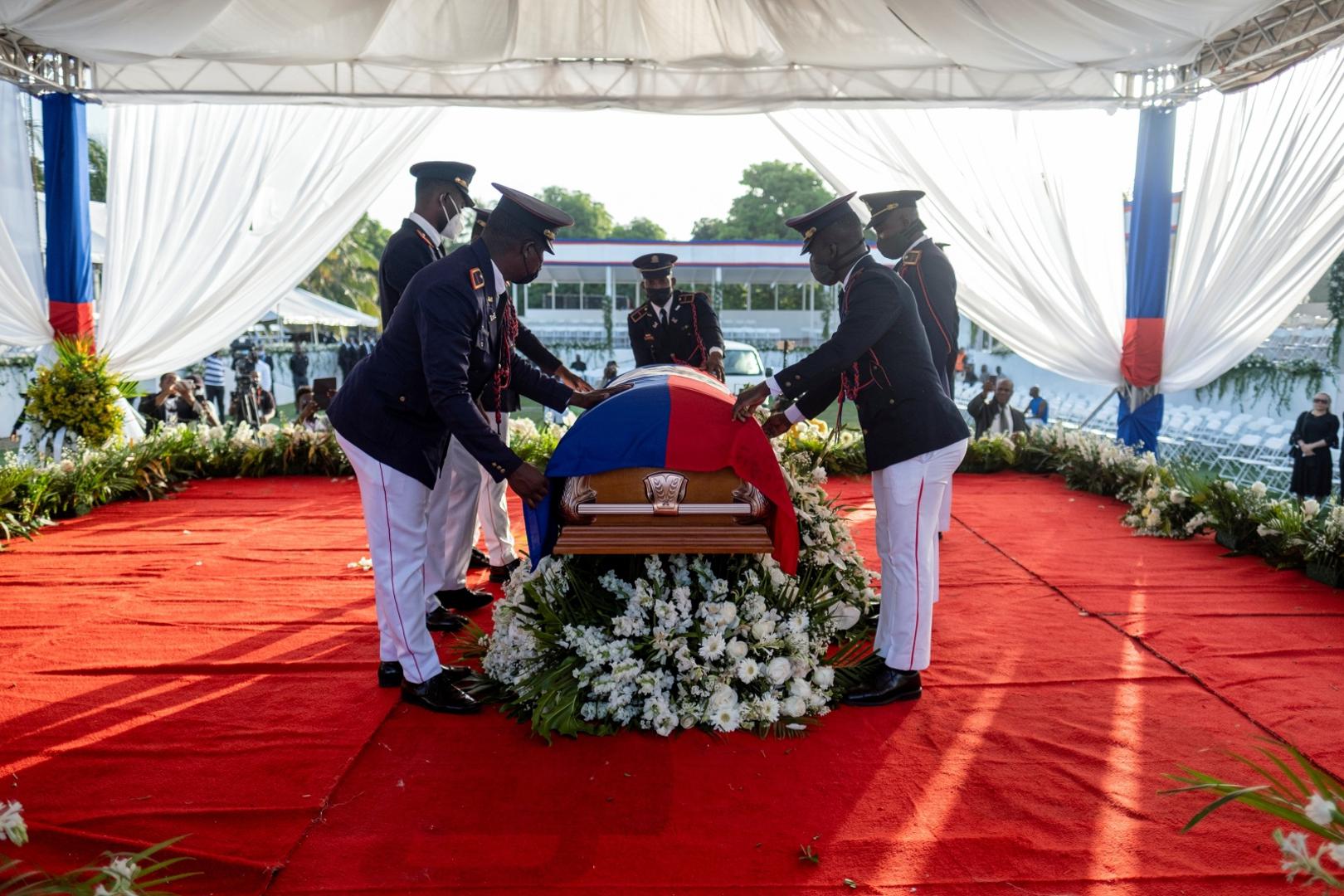 Haiti holds funeral for assassinated President Jovenel Moise in Cap-Haitien Presidential honor guards place a national flag over the coffin of late Haitian President Jovenel Moise, who was shot dead earlier this month, during the funeral at his family home in Cap-Haitien, Haiti, July 23, 2021. REUTERS/Ricardo Arduengo RICARDO ARDUENGO