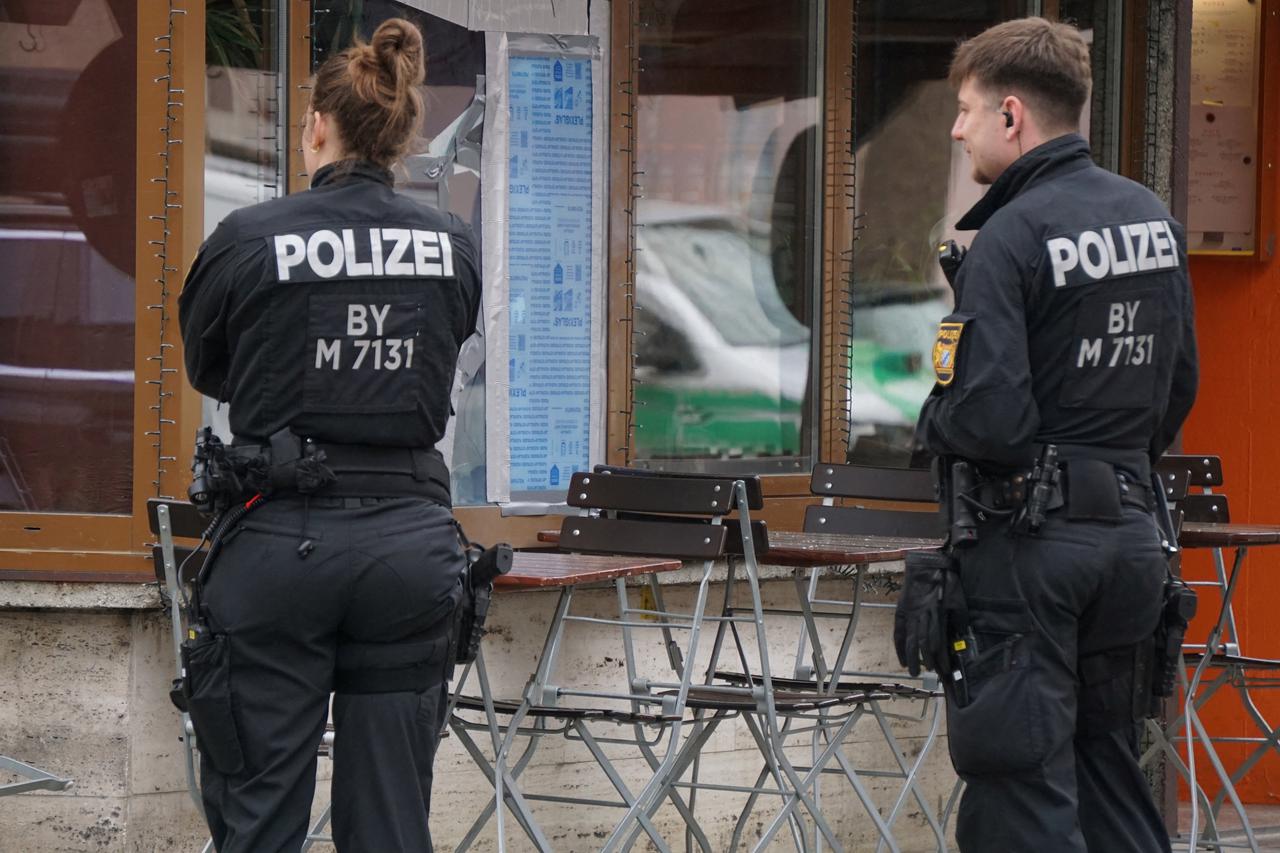 German police secures the area in front of an Israeli restaurant with broken windows in Munich