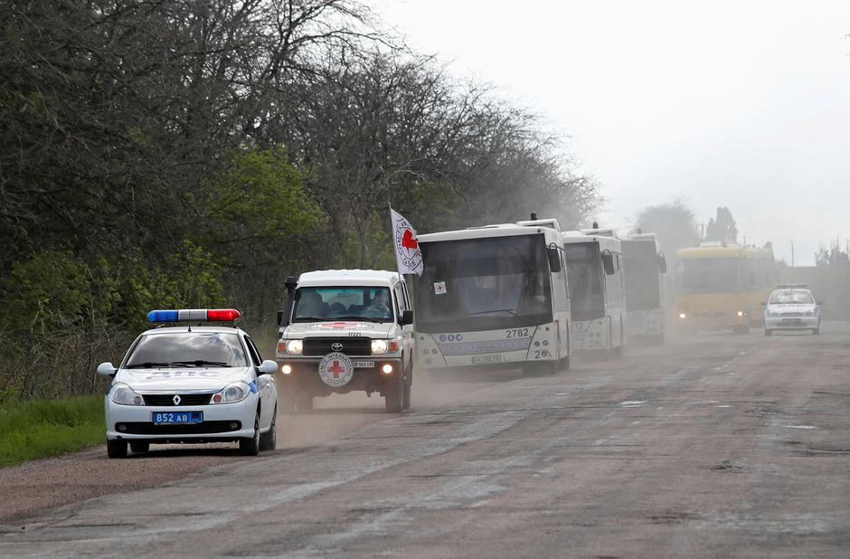 A convoy carrying evacuees from Mariupol area is seen on a road in the Donetsk Region