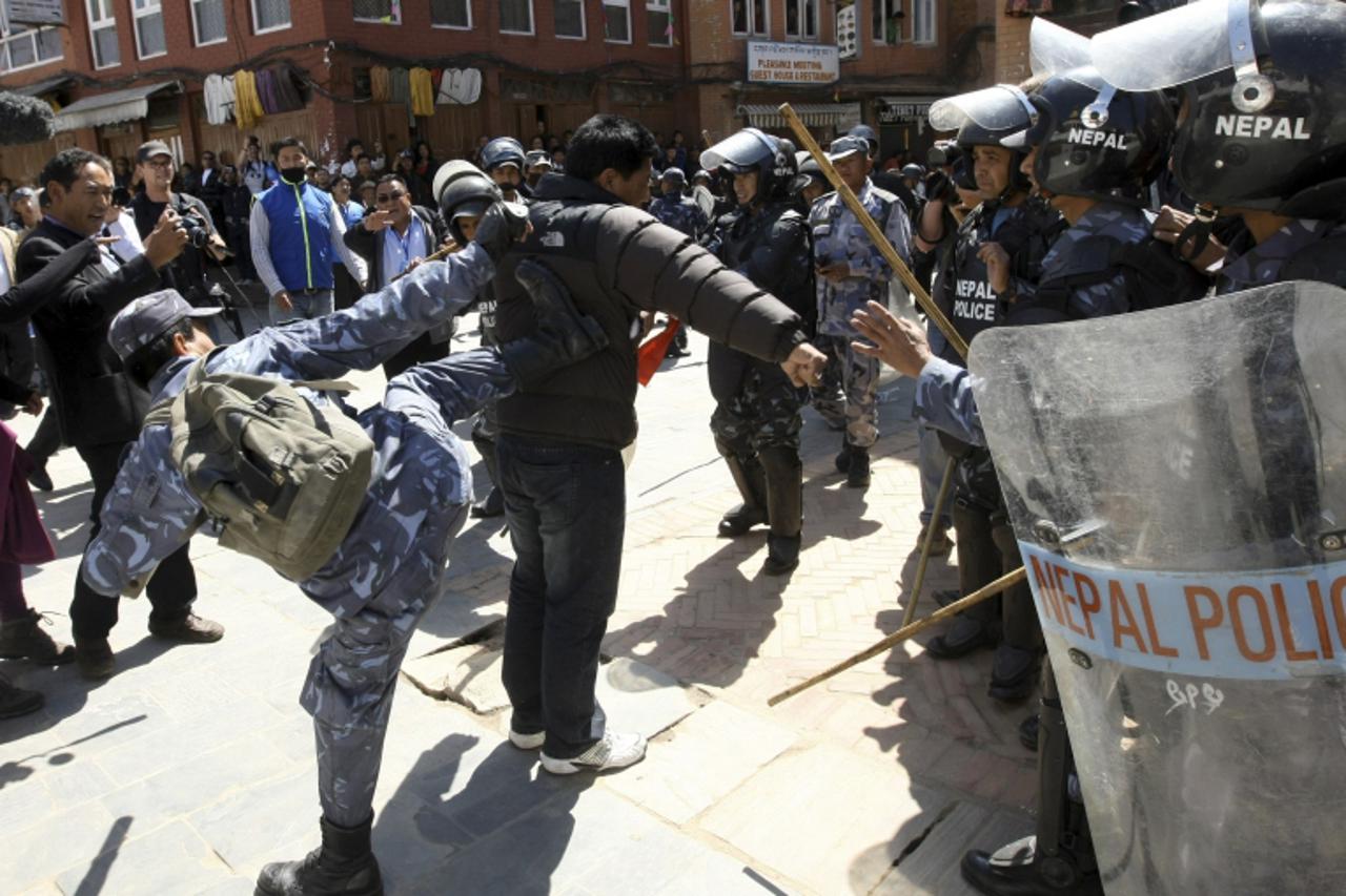 'Nepalese riot police charge Tibetan activists at Boudhanath in Kathmandu on March 10, 2011, during a protest to mark the 52nd anniversary of the Tibetan uprising. The protest marked the anniversary o