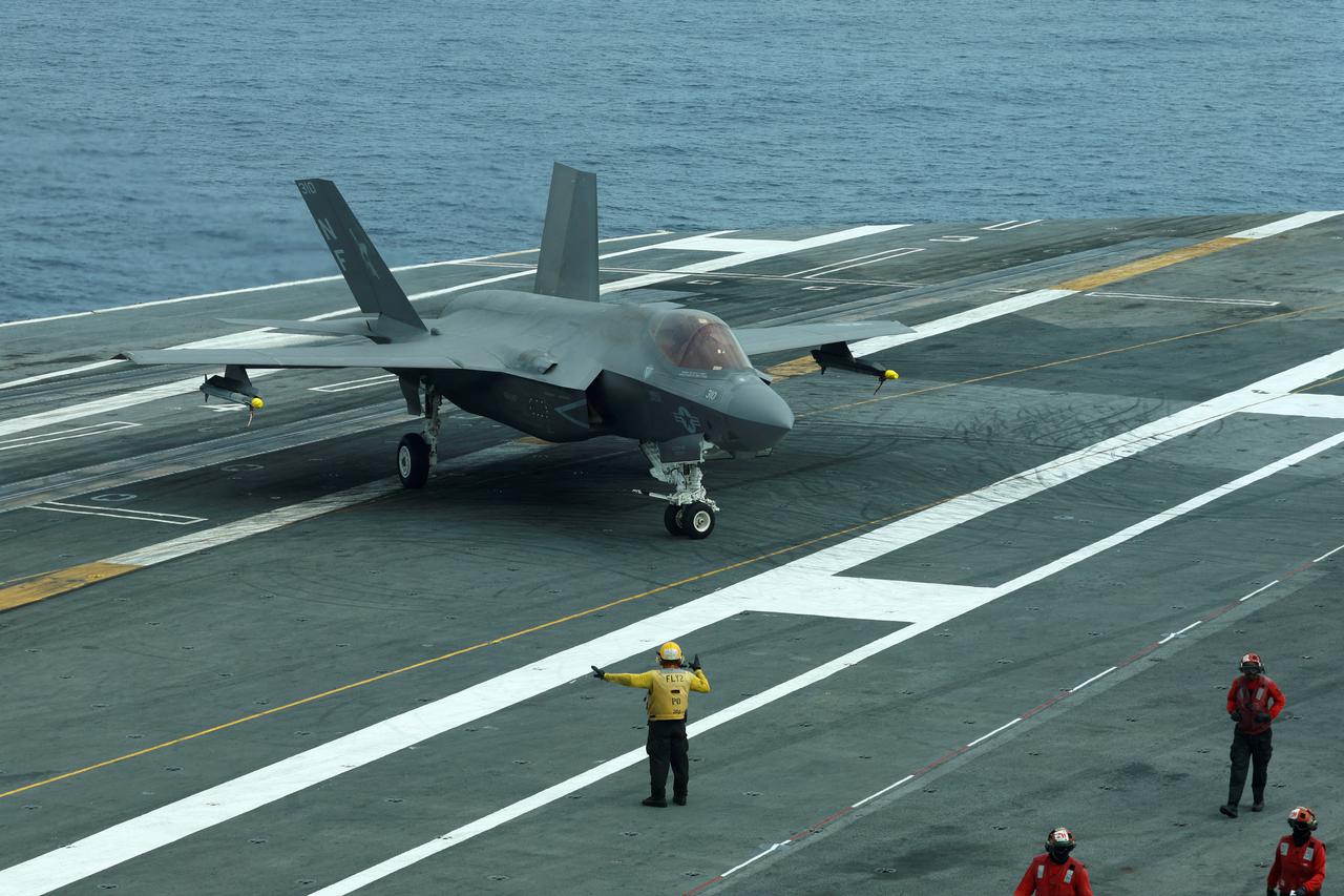 FILE PHOTO: A flight deck crew signal to F-35 jet on USS George Washington during Freedom Edge trilateral exercise among United States, Japan and South Korea in the East China Sea, south of the Korean peninsula and west of Japan's main islands