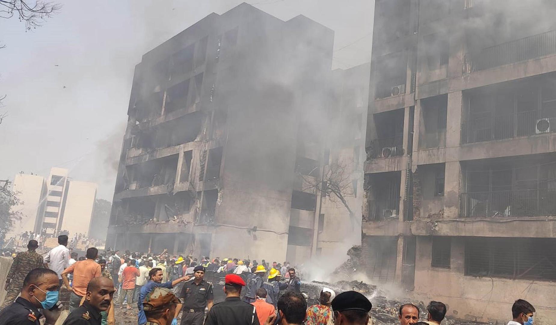 (250612) -- AHMADABAD, June 12, 2025 (Xinhua) -- People and rescuers are seen at a site of a plane crash in Ahmedabad of India's Gujarat state, June 12, 2025. An Air India flight to London crashed Thursday shortly after takeoff from an airport in the western Indian state of Gujarat, officials said.    The flight with 242 people, including 230 passengers and 12 crew members, onboard took off from the Sardar Vallabhbhai Patel International Airport in Ahmedabad, about 17 km south of Gandhinagar, the capital city of Gujarat.    Reports said the passenger aircraft went down in the Meghani area of the city. (UNI/Handout via Xinhua) Photo: UNI/XINHUA