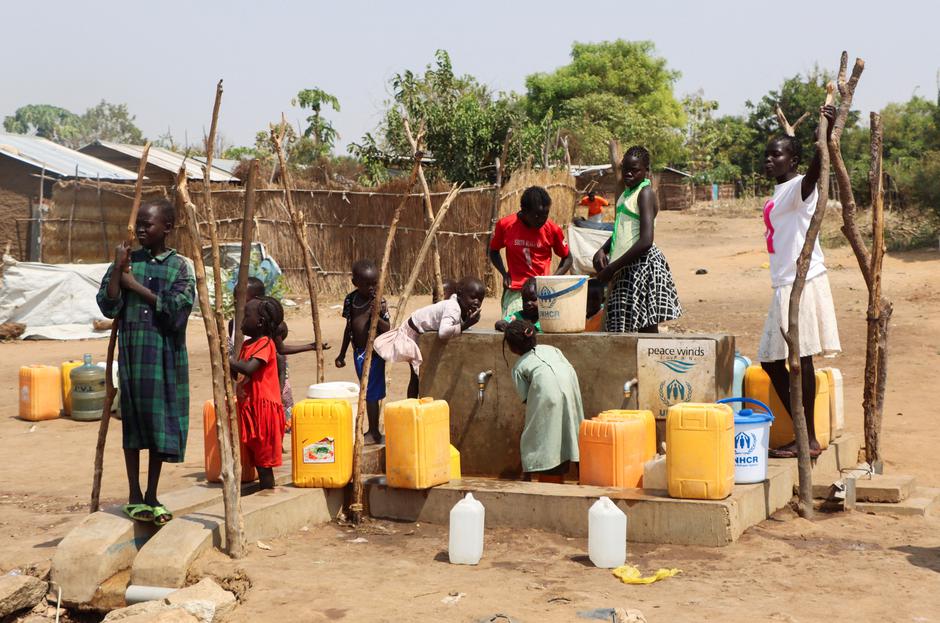 Sudanese refugees collect water from a borehole at the Gorom Refugee camp