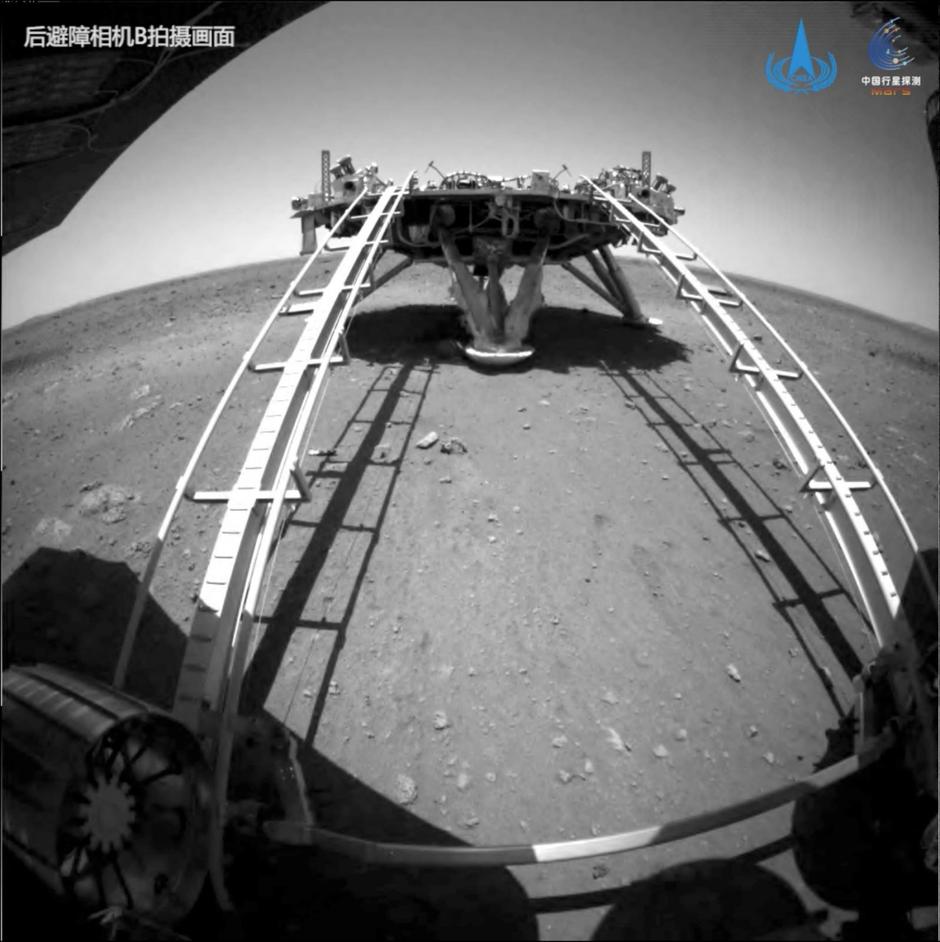 Handout image of Chinese rover Zhurong of the Tianwen-1 mission driving down the ramp of the lander onto the surface of Mars