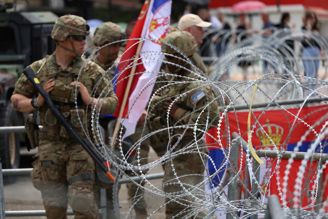 U.S. KFOR soldiers, under NATO, stand guard near a municipal office in Leposavic