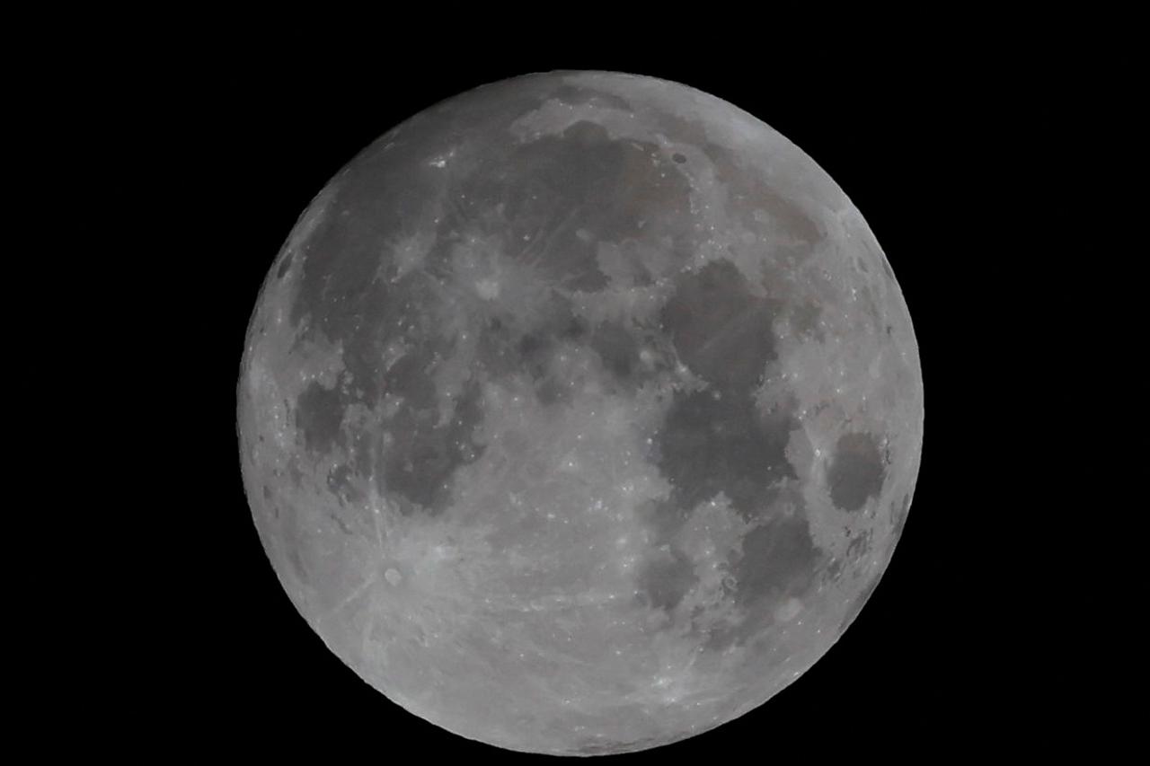 The full moon is seen shinning in the zenith of the sky in Ronda