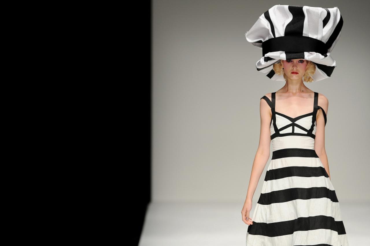 'A model displays creations by Kinder Aggugini for the Spring/Summer 2010 collection on the second day of the London Fashion Week, in central London, on September 19, 2009. AFP PHOTO/Ben Stansall'