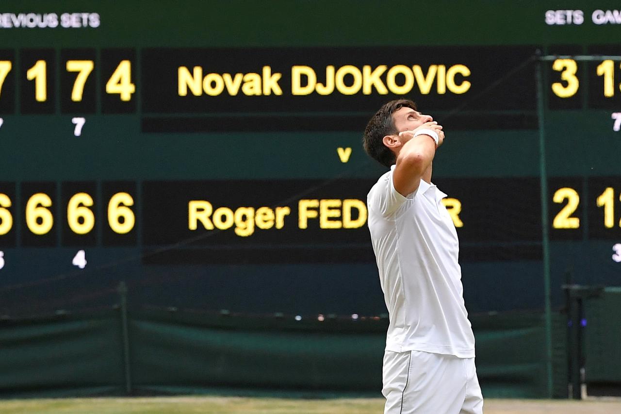 FILE PHOTO: Serbia's Novak Djokovic celebrates winning the 2019 Wimbledon final against Switzerland's Roger Federer