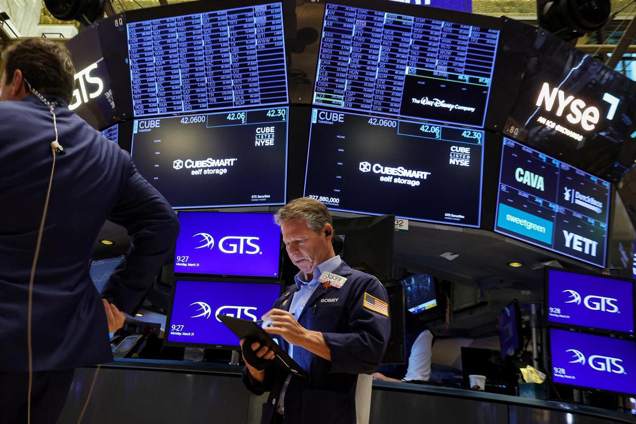 Traders work on the floor of the NYSE in New York