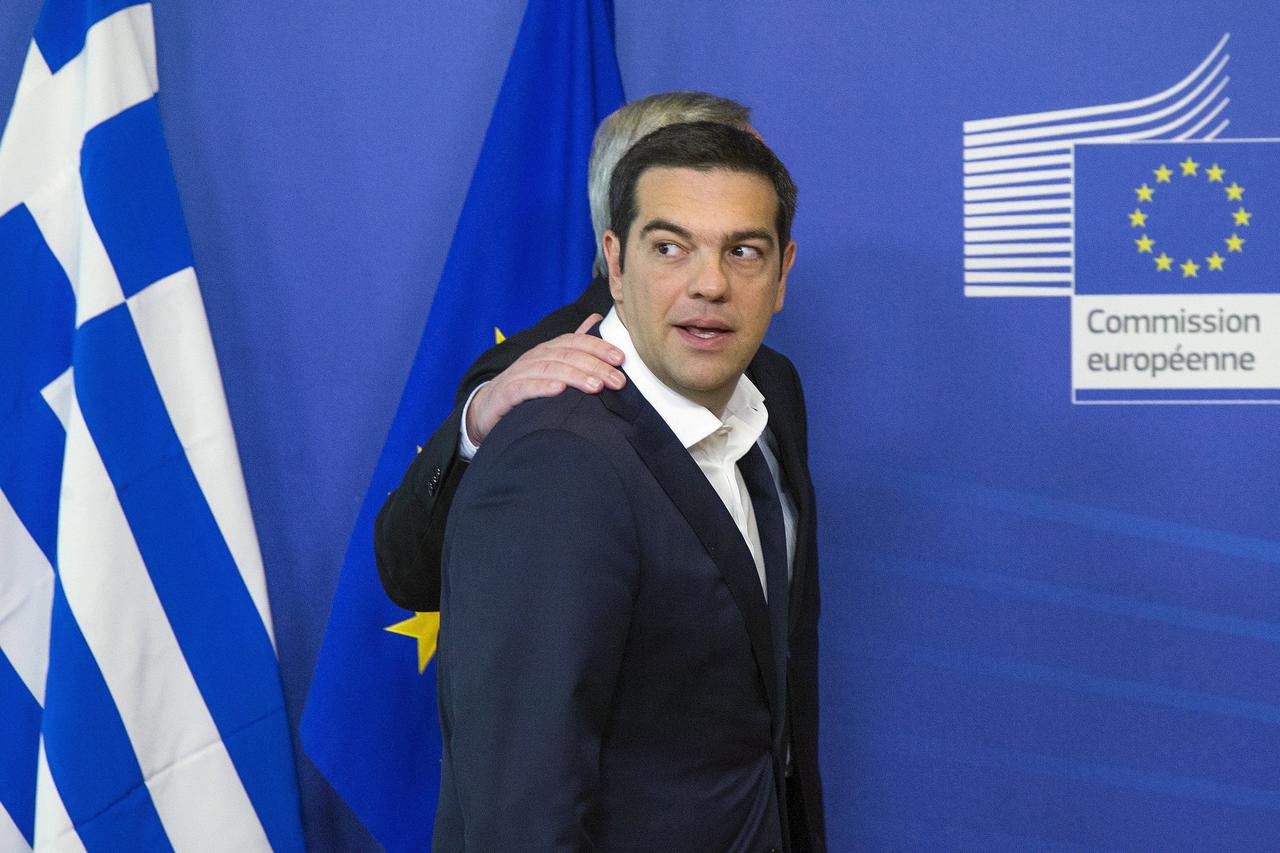Greek Prime Minister Alexis Tsipras (front) is welcomed by European Commission President Jean Claude Juncker for a meeting ahead of a Eurozone emergency summit on Greece in Brussels, Belgium in this June 22, 2015 file photo. To match Special Report EUROZO