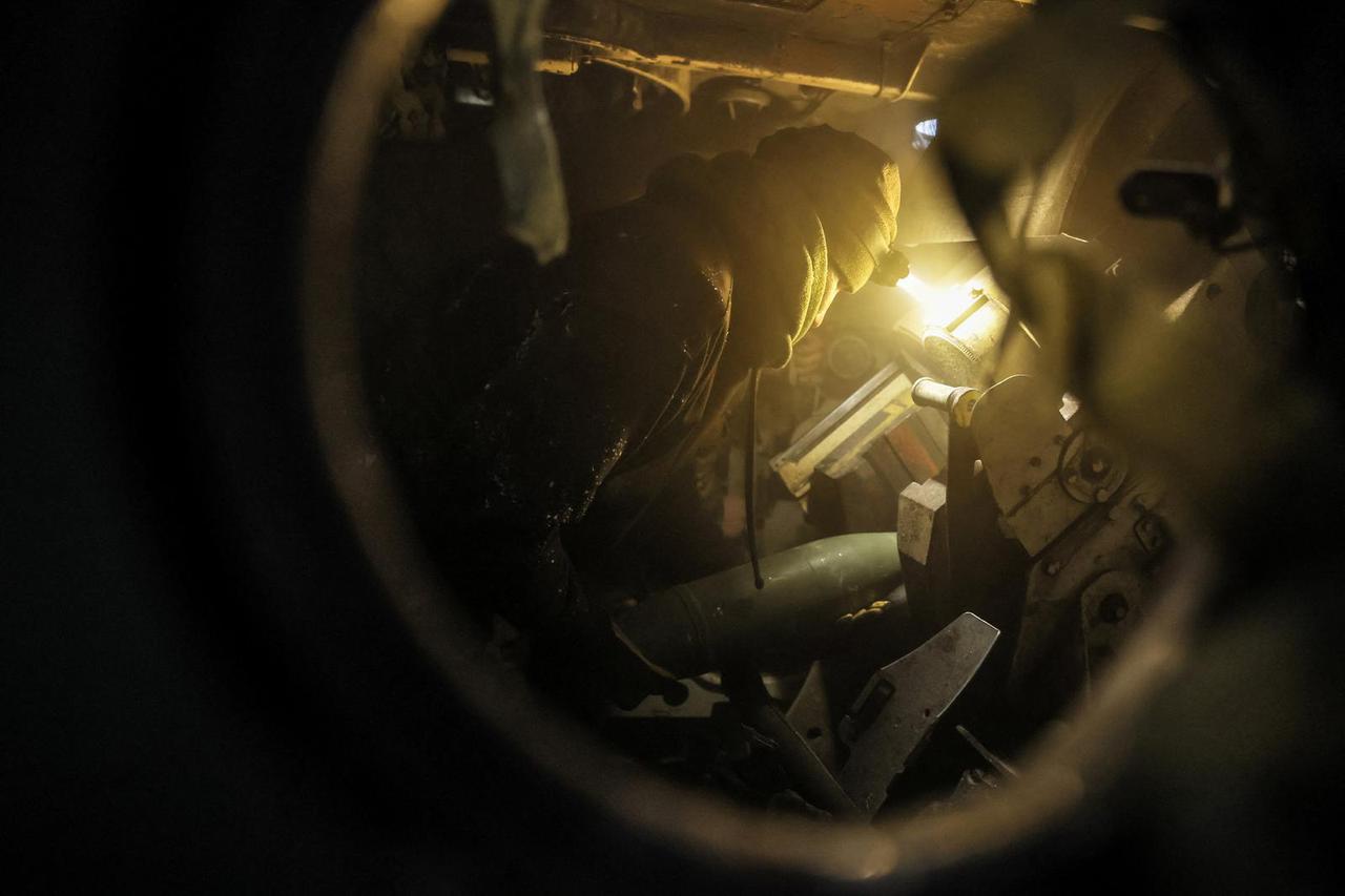 Ukrainian servicemen fire a self-propelled howitzer towards Russian troops near the frontline town of Chasiv Yar