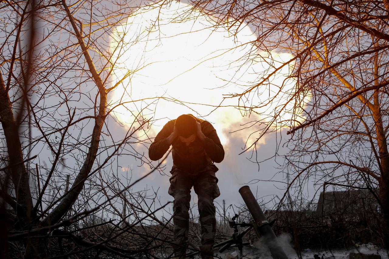 FILE PHOTO: A Ukrainian serviceman fires a 120-mm mortar towards Russian troops at a frontline near the town of Vovchansk