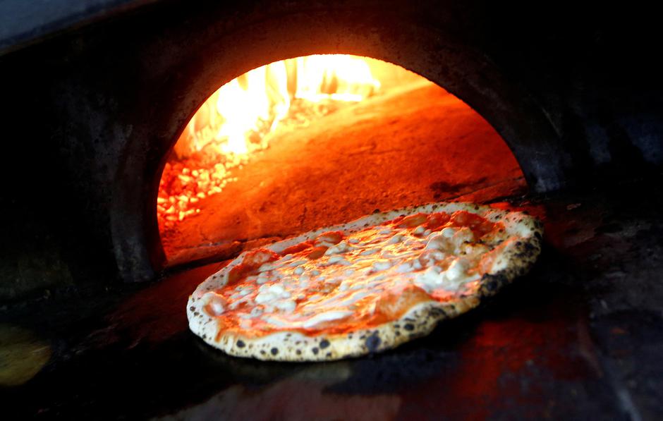 FILE PHOTO: Pizza Margherita is prepared in a wood-fired oven at L'Antica Pizzeria da Michele in Naples