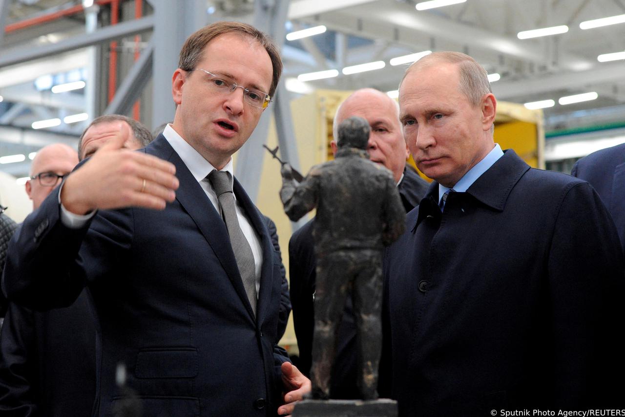 FILE PHOTO: Russian President Putin listens to Culture Minister Medinsky as they watch the project of a monument to Kalashnikov, the Russian inventor of the AK-47 assault rifle, during a visit at firearms maker Kalashnikov Concern in Izhevsk, Russia