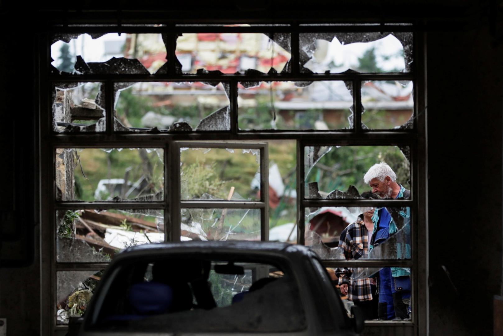 Aftermath of rare tornado in Czech Republic People are seen through a damaged window in the aftermath of a rare tornado that struck and destroyed parts of some towns, in Mikulcice village, Czech Republic, June 25, 2021. REUTERS/David W Cerny DAVID W CERNY
