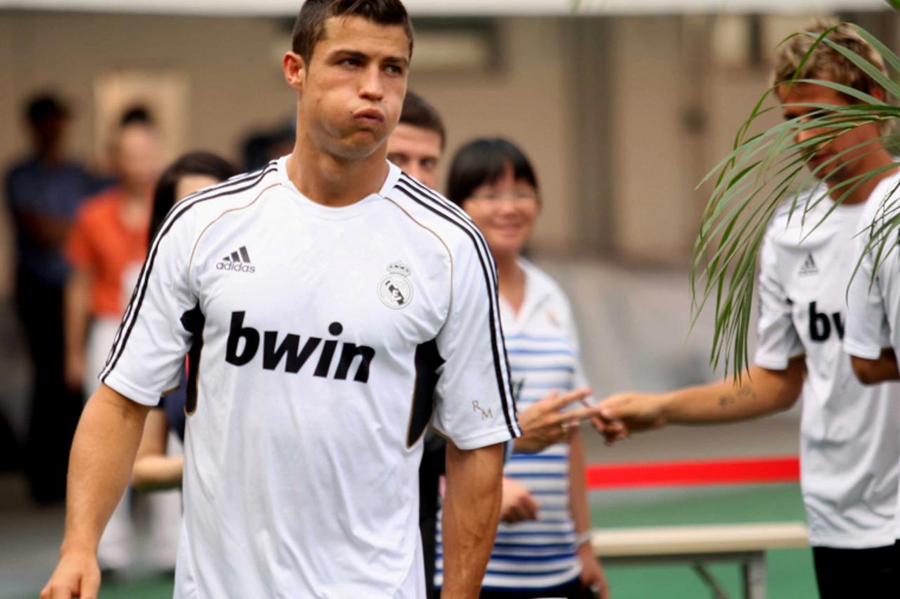 'This photo taken on August 1, 2011 shows Real Madrid\'s Cristiano Ronaldo reacting as he takes part in a training session in Guangzhou, in southern China\'s Guangdong province. Real will take on Guan
